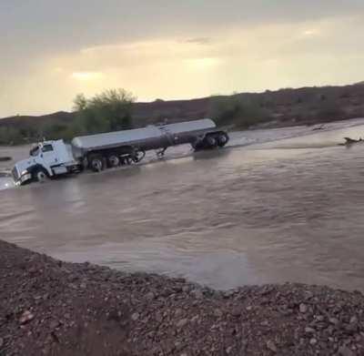 Semi-truck drives straight into flood waters