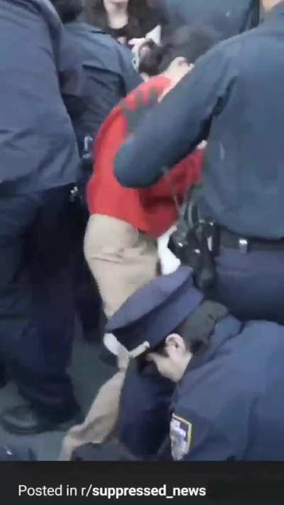 NYPD officers beating and singling out a protestor who had keffiyeh wrapped around his face