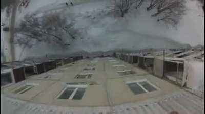 Guy lights himself on fire and jumps off of a roof into a pile of snow