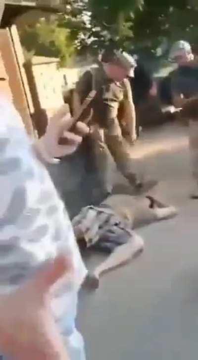 ua pov: Military recruitment officers knock a civilian out and drag him on the floor.