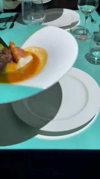 Kid enjoys a show with dinner.