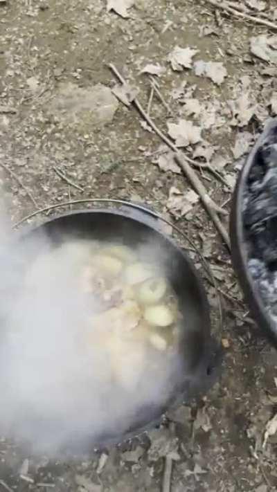 Brined and Braised pork shoulder outside in the Dutch oven