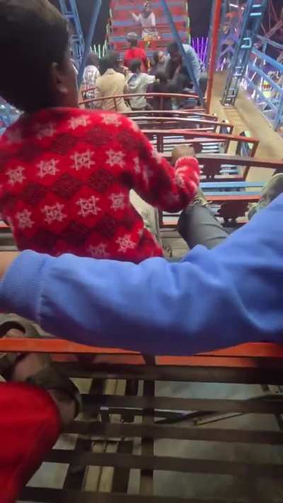 Trying to board a fairground ride.