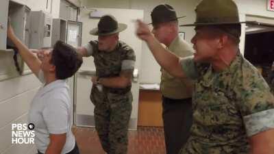 Marine Corps drill instructors picking on the last recruit to make their phone call home after arriving at boot camp