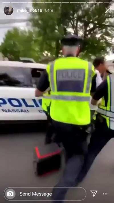 East Meadow, NY: a police officer abruptly stops walking so a protestor walking behind him will bump into him, so the other police can attack and arrest him.