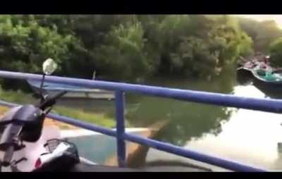 Singing while sitting on the edge of a bridge fence