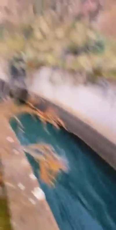 Waterslide of death: an open canal that's channeled down a valley, under a river, and then up the other side. Location unknown