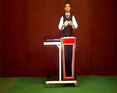 How is this done? Is he simply leaning toward his right? Or is he sitting sideways but twists his hips toward the camera?