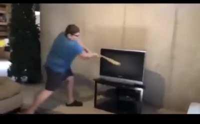 Ungrateful kid smashes tv with a bat
