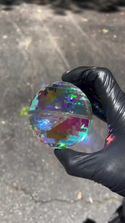 A dichroic glass marble I created and faceted.