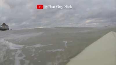 surfing under a pier