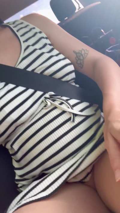She gets so daring in the car, teasing with both her full breasts and her swollen kitty