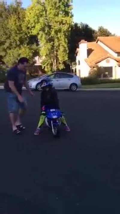 Poor creature... this motorcycle is too small for the boy.