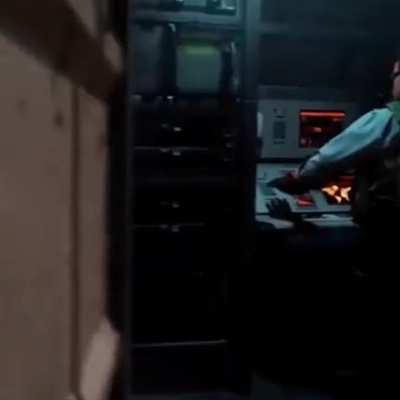 The funny looking button is on the desk