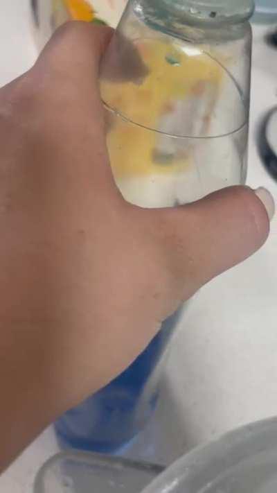 Can anyone explain this soap bubble in our dish soap that sporadically floating and moving on the same invisible plane? Is this a glitch in the simulation?