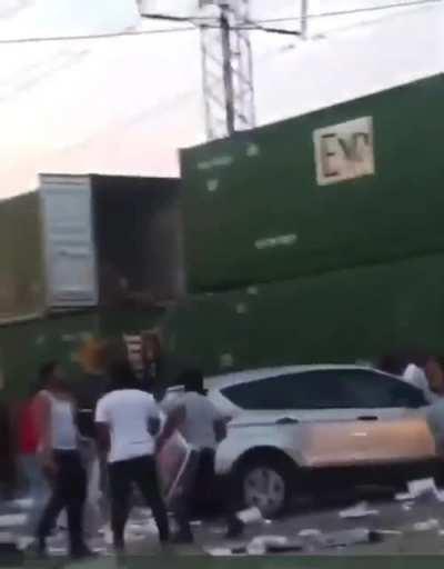Looters raid cargo containers containing high-end TVs