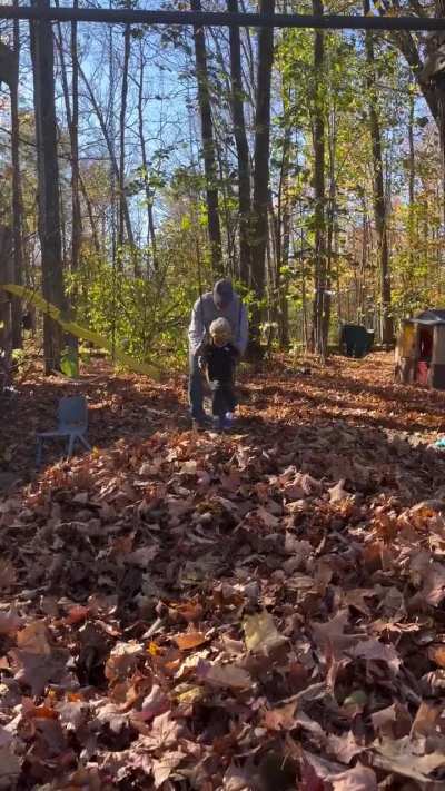 Jumping off a swing into a pile of leaves