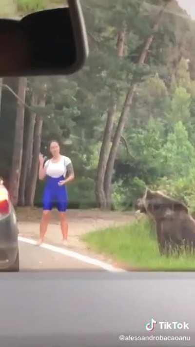 Posing for a photo with a bear