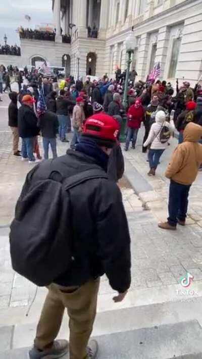 The surreal moment that a Trump supporter begs cops to intervene in the Capitol riots.