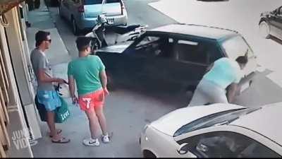 Man picks up car to get out of parking space