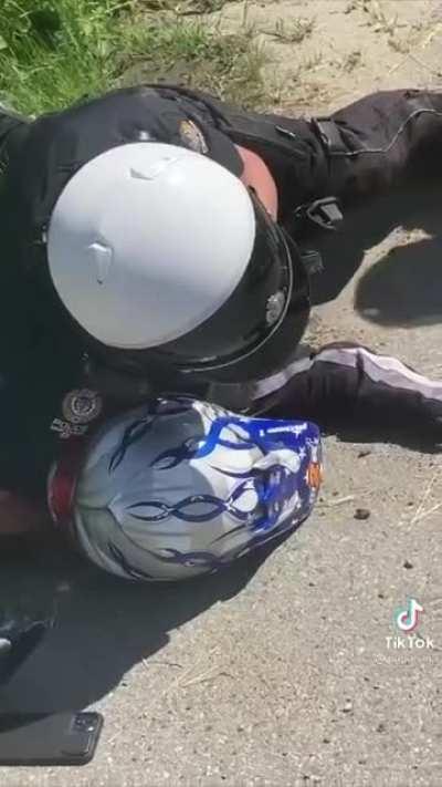 Police officer does a hard takedown on a biker during a traffic encounter