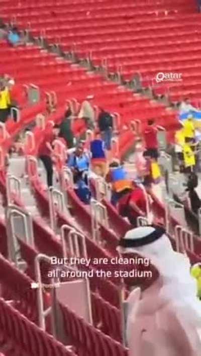 Japanese fans at the opening World Cup match cleaned up the stands after Qatar vs Ecuador.