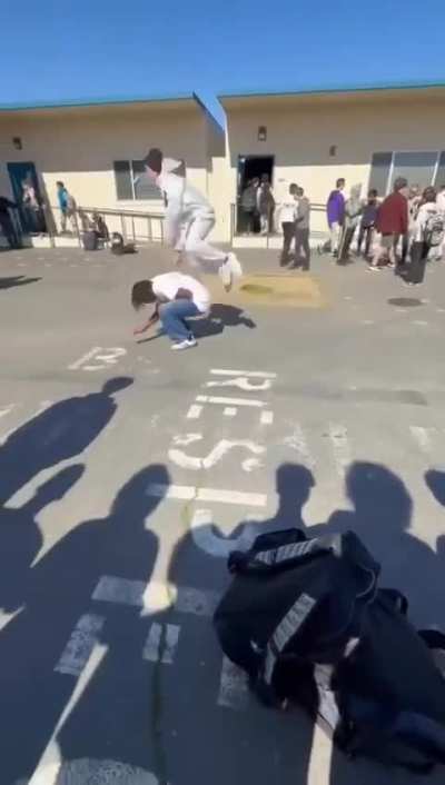dude eats it after trying to jump over someone