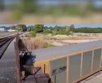 Train tries to carry some valuable cargo under a too-low bridge