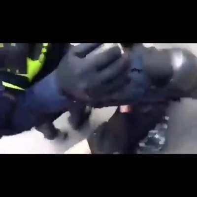 Police kicking a woman who fell during protest