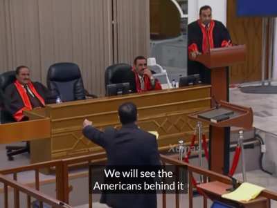 Saddam Hussein arguing with the judges and prosecutors during his trial