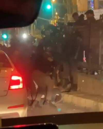 Israeli soldiers attacking a man before arresting him