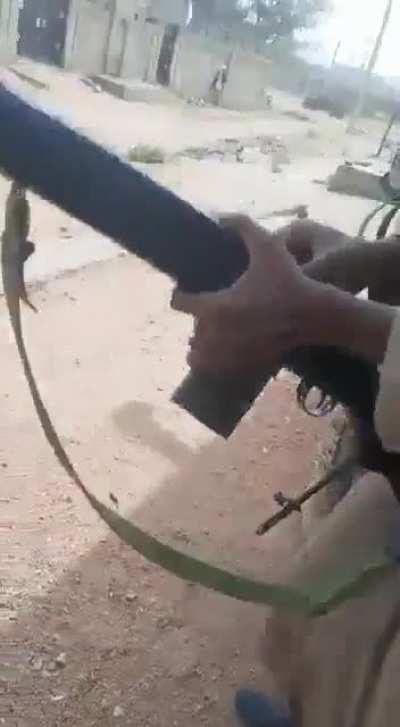 What appears to be a mixed group of armed civilians and soldiers in a gun battle in Sudan