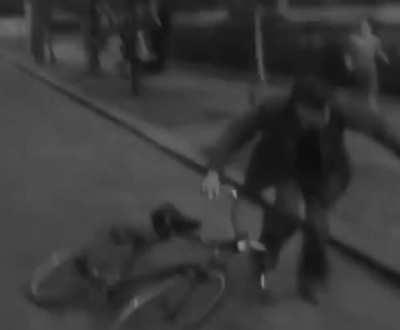 This monkey in a suit, riding a bicycle