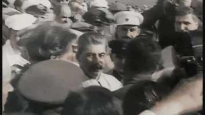 Stalin kissing another man. This is a way of greeting each other
