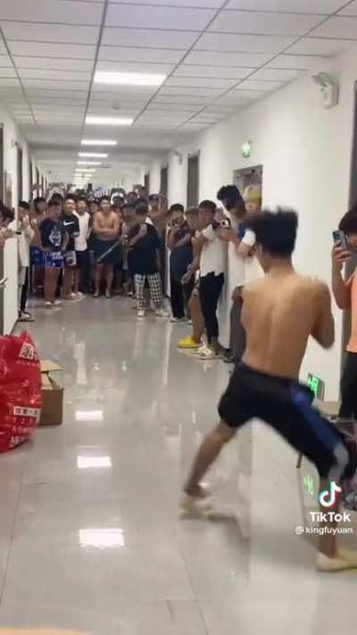 Chinese college students practice Kung fu in the hallway