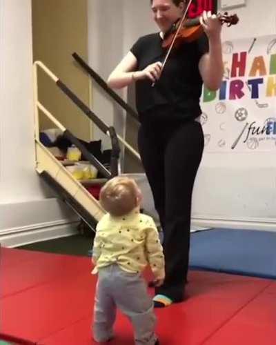 This little guy hearing a violin for the first time