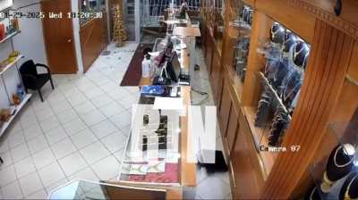 Car plows through storefront in apparent robbery attempt.