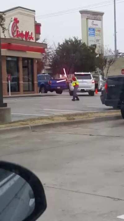 Parking lot attendat with real lightsabers...