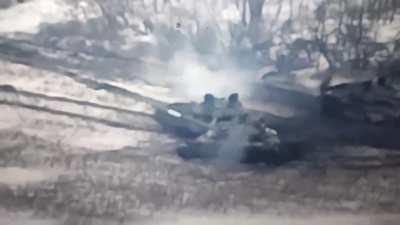 A Russian who is on fire is running away from his tank which is also on fire and about to explode