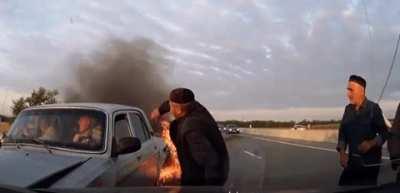 Bystanders help elderly people in a car accident.