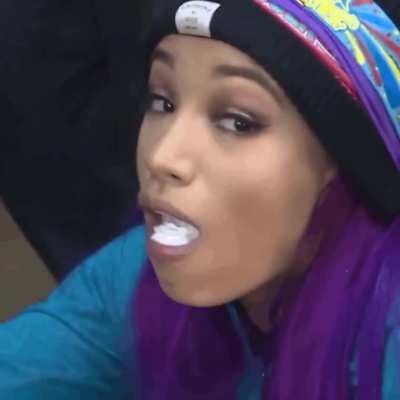Sasha Banks taking a massive shot of a white substance in her mouth and swallowing