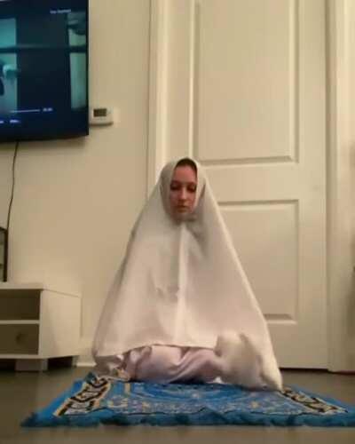 Cute kitten demands attention while owner is praying.