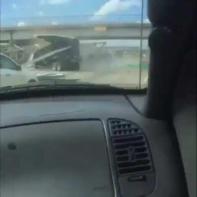 Truck drives into highway sign