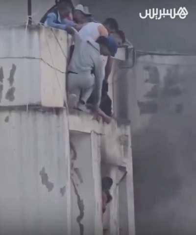 Civilians saving children from burning building
