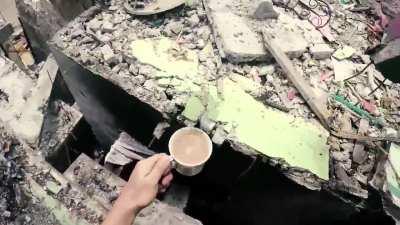 A Philippine SOC fighter carries coffee to his commander during the battle for the city of Marawi against an ISIS group.