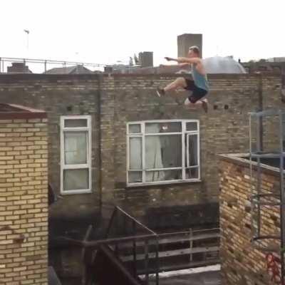 Free runner making a jump that doesn't look possible