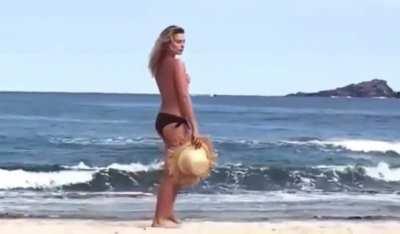 Walking topless on a beach