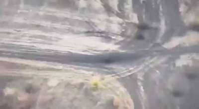 A Russian soldier on a moving vehicle was directly hit on the back of the head by an FPV drone operated by the 