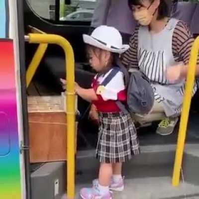 Little girl taking the school bus