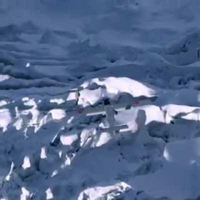 Wingsuit flying from a mountain to land on an airplane